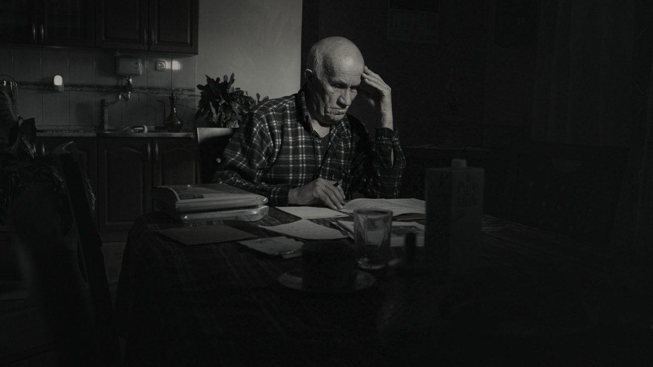 A man at a table surrounded by documents